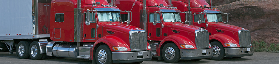 Three red semi trucks parked next to each other | improve CSA scores