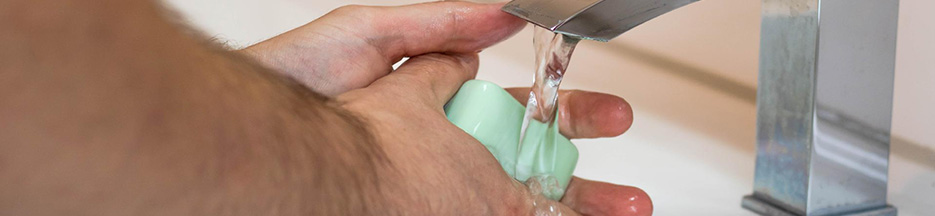 A Trucker washes his hands with soap | trucking safety during a pandemic